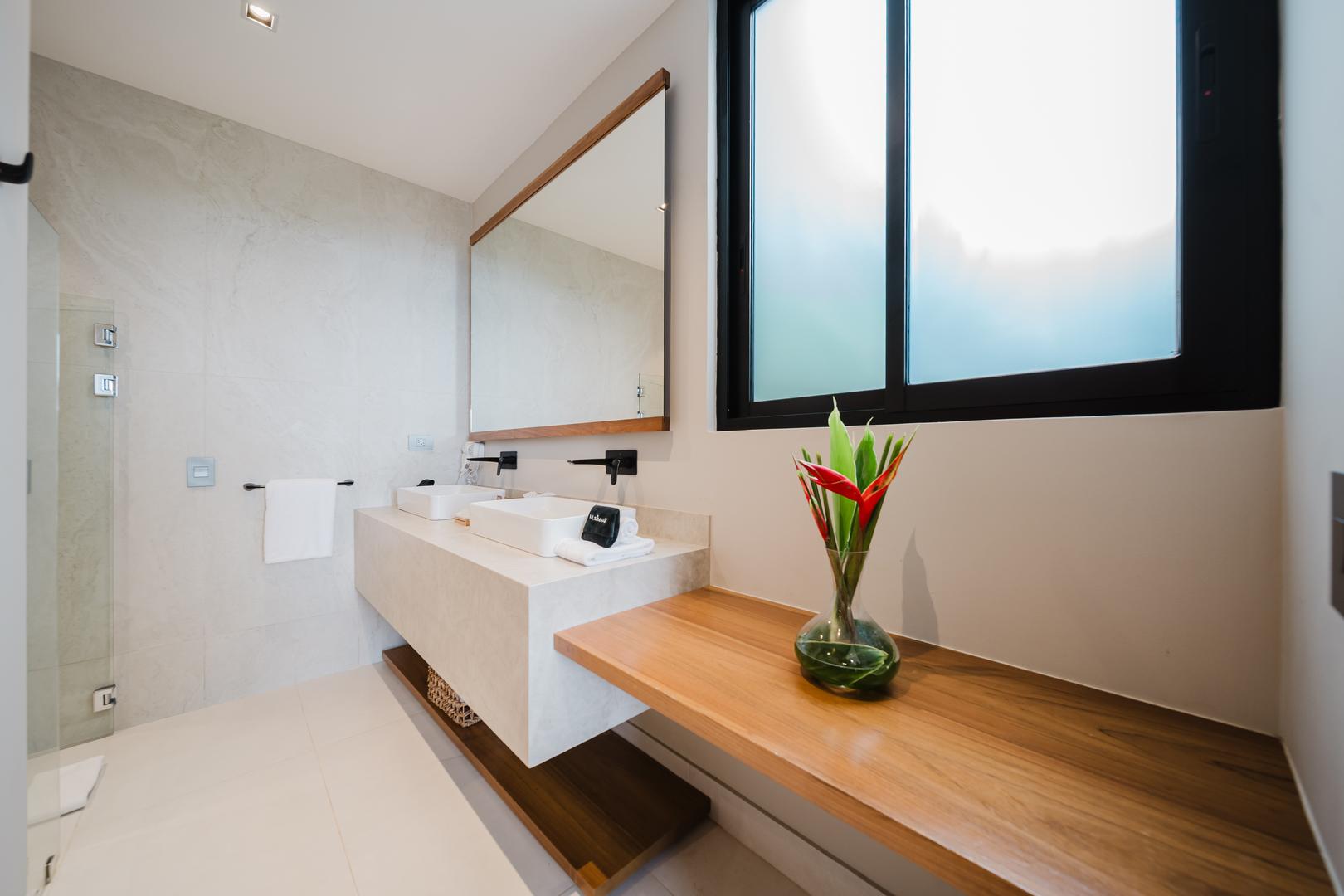 Modern bathroom with double vanity and natural light in Manuel Antonio Costa Rica