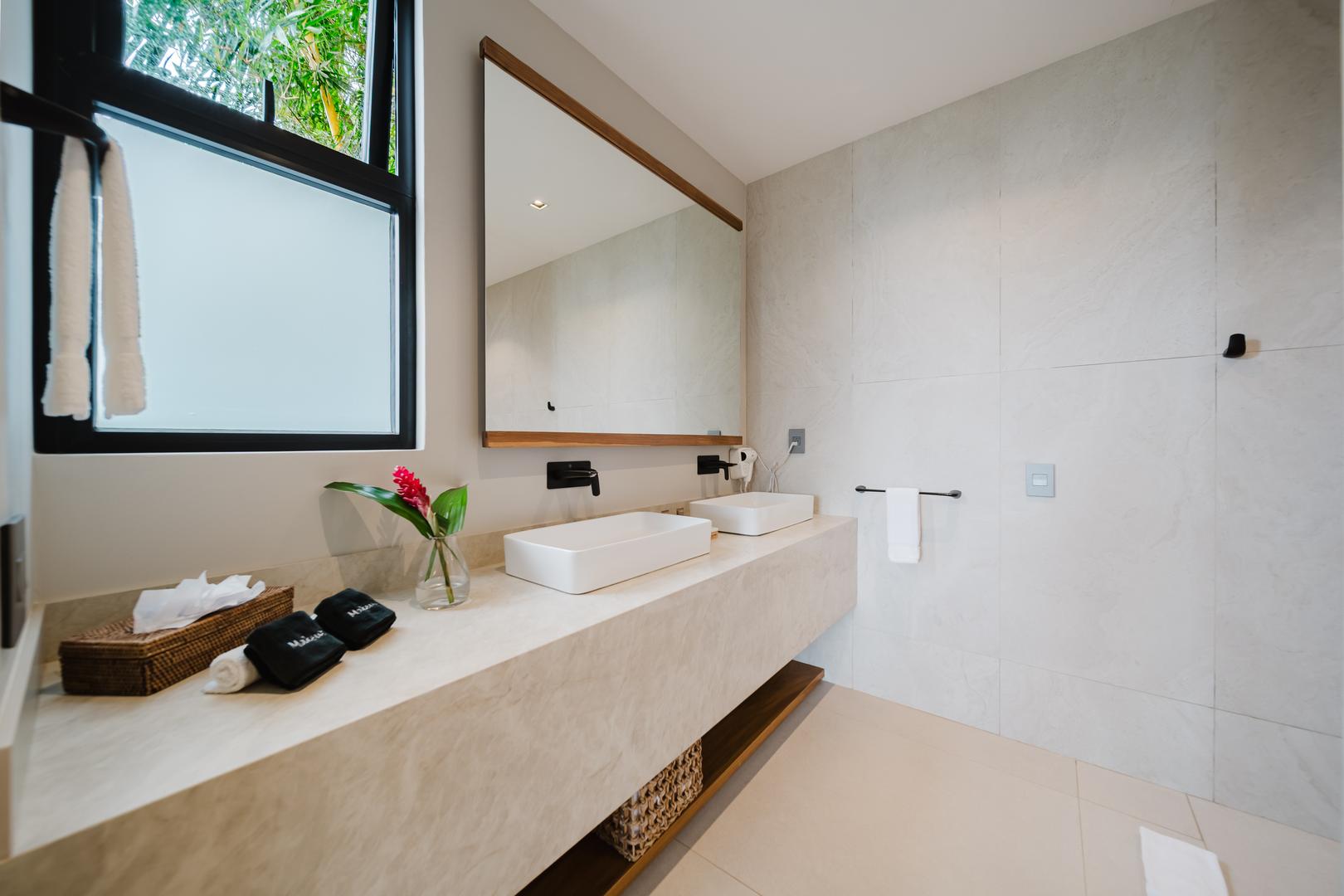 Modern bathroom with double vanity sinks and mirrors in Manuel Antonio Costa Rica