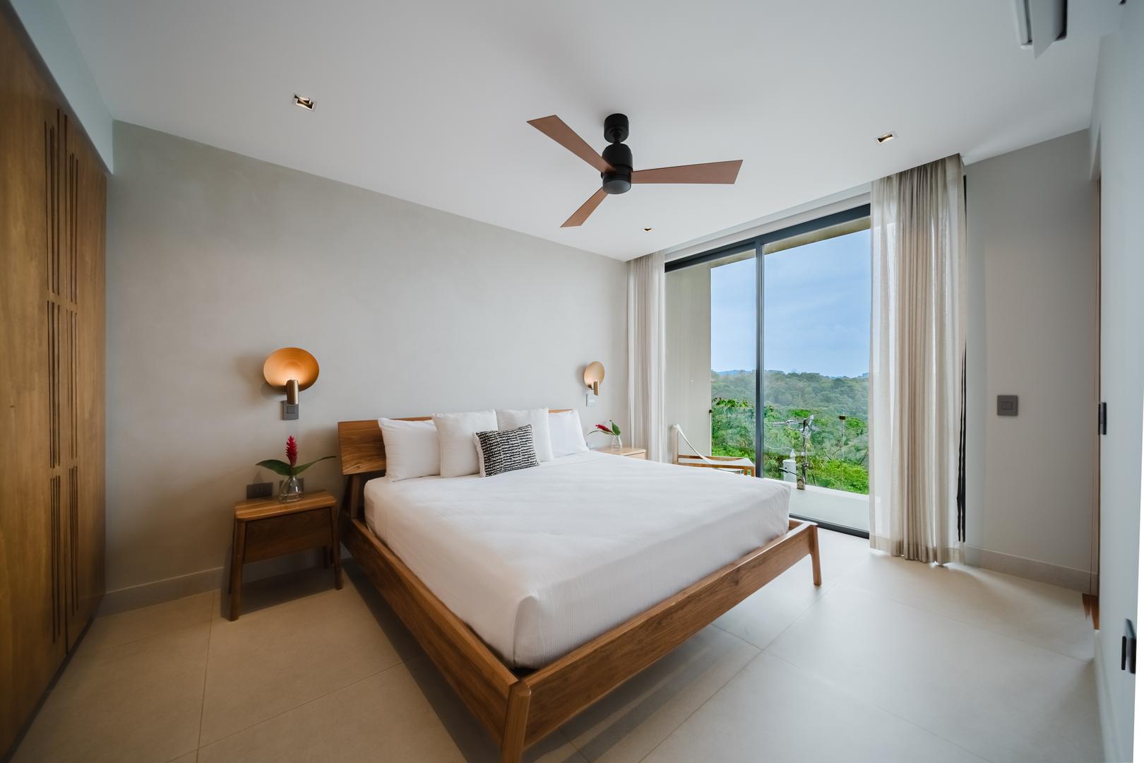 Bedroom with jungle and ocean view through glass doors in Manuel Antonio Costa Rica