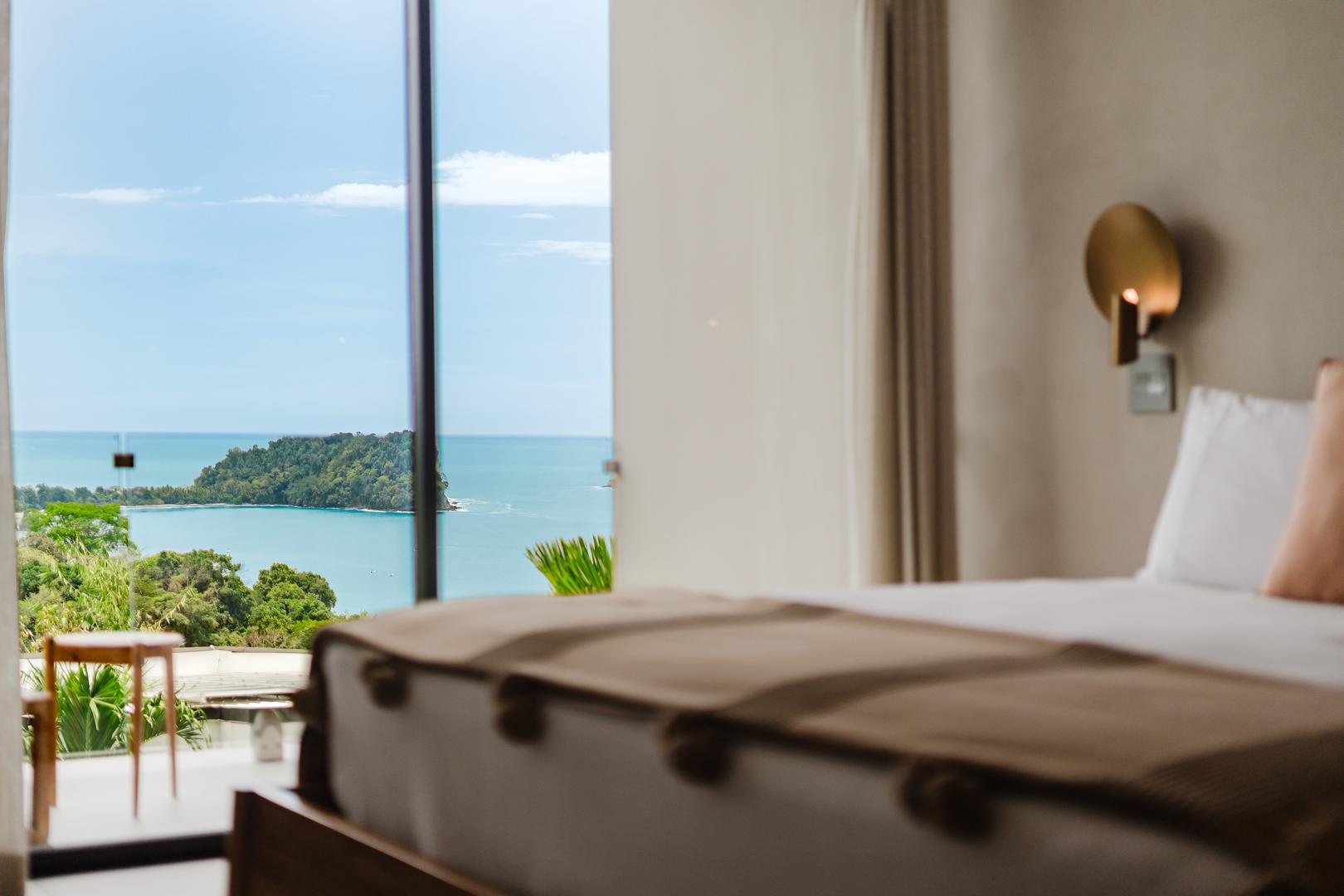 Bedroom detail with bed in foreground and ocean view through window Manuel Antonio Costa Rica
