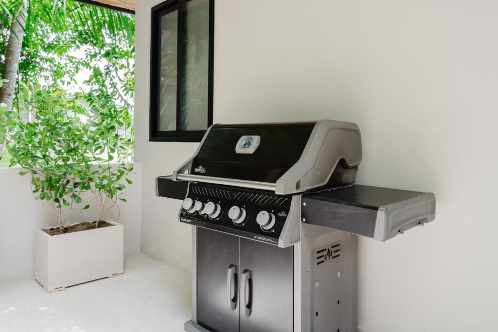 An outdoor grill set within the terrace, where cooking becomes part of the gathering.