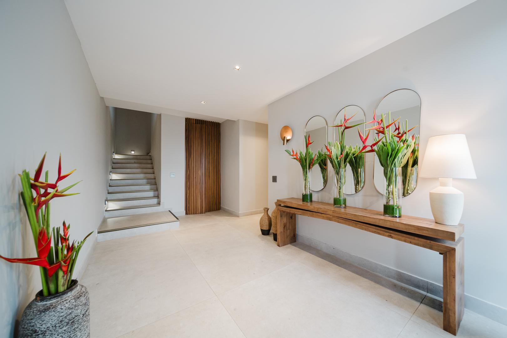 Modern foyer with wooden console table and decor in Manuel Antonio Costa Rica