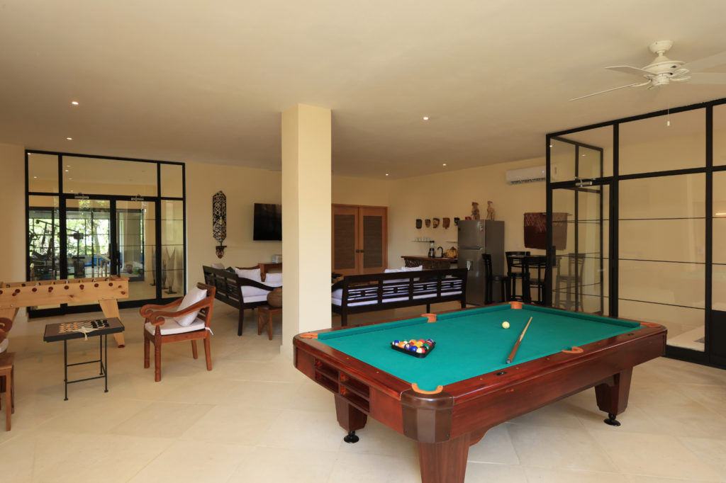 Our spacious, fully-equipped entertainment area offers a regulation-size pool table and foosball, alongside elegant cozy seating and snack amenities.