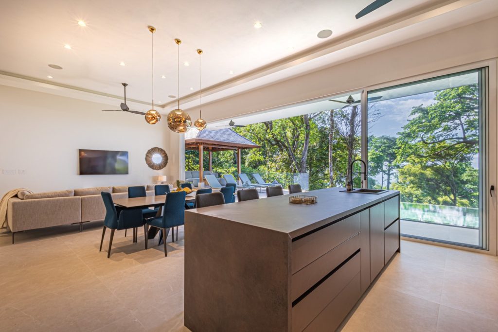 The gorgeous open-plan living area has huge glass sliding doors that can open up to the ocean breeze.
