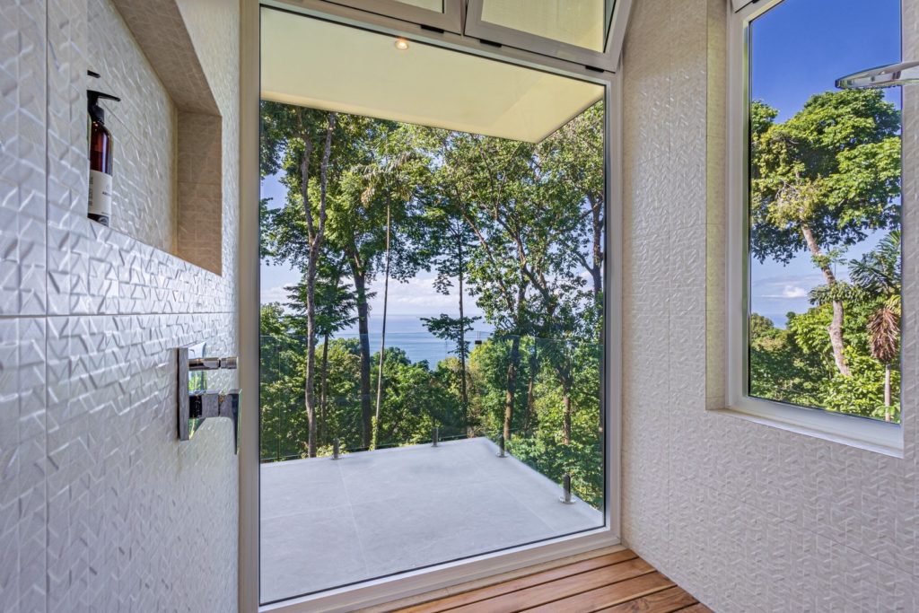 This shower is the height of luxury with floor-to-ceiling rainforest and ocean views for a truly immersive experience.