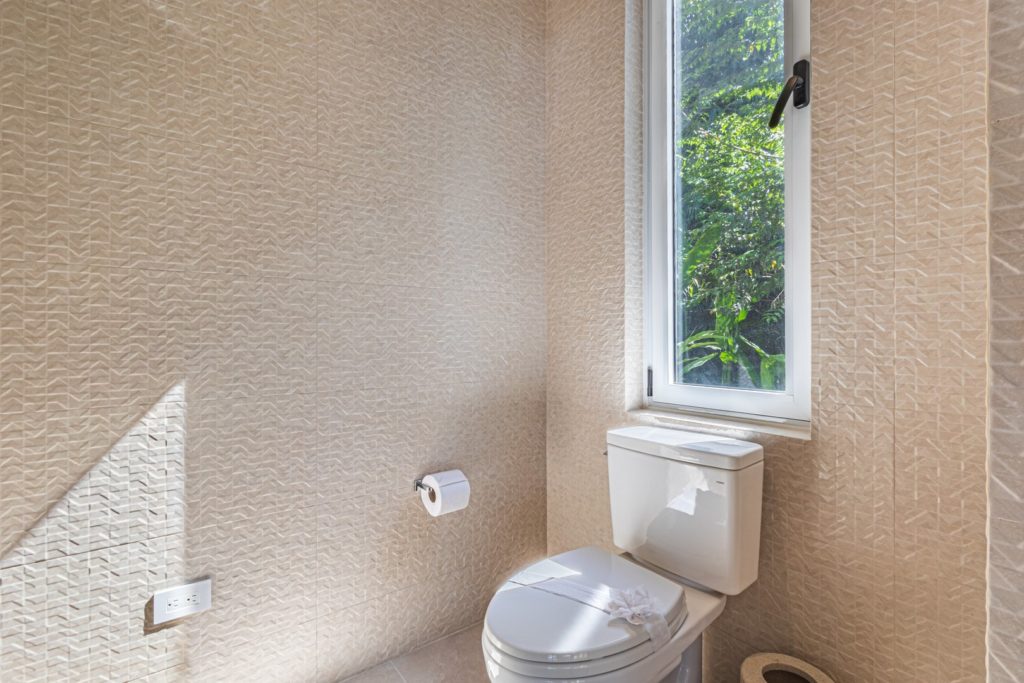 Simple yet elegant design in the bathrooms lets the lush jungle view through every window become the main feature.