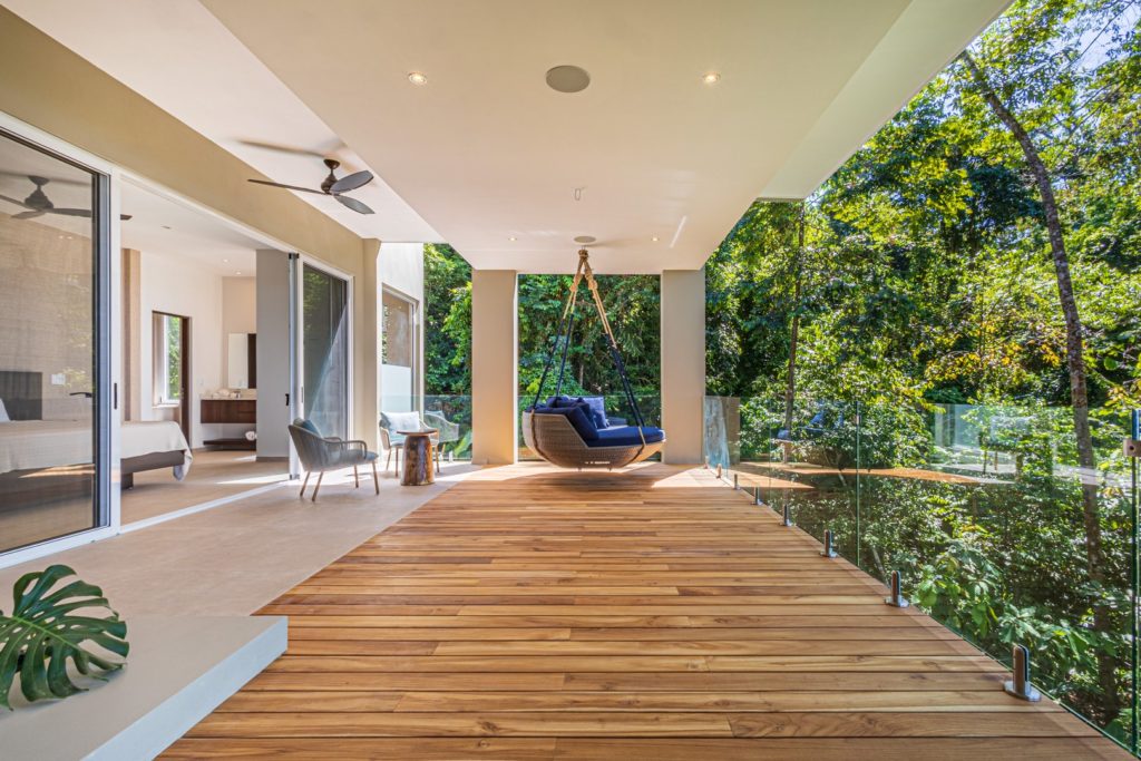 This incredible wood and glass balcony minimizes any distraction from the beautiful rainforest that surrounds it.