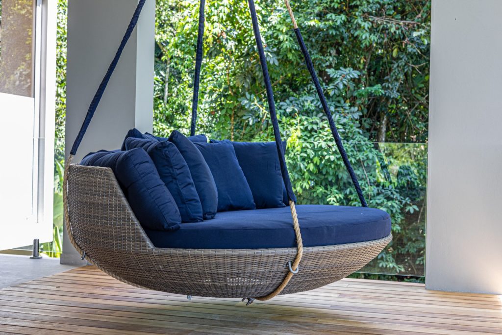 This inviting luxury hanging daybed is ideal for a nap or relaxing with a good book.