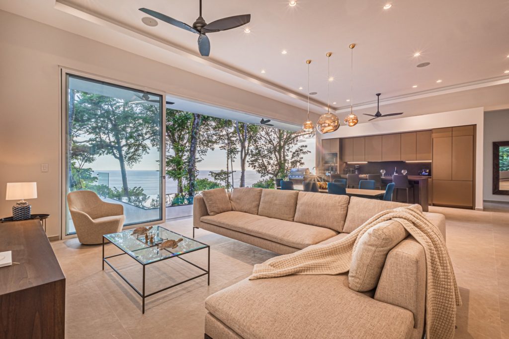The open-plan great room has luxury furnishings like this huge sectional providing optimum comfort for your guests.