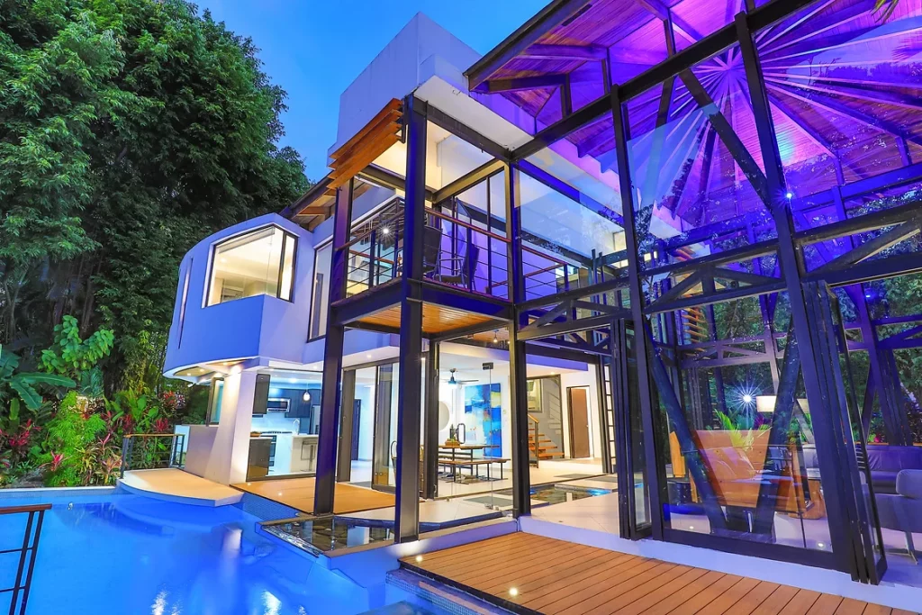 In the evening, by the poolside, this remarkable modern house undergoes a beautiful transformation when illuminated.
