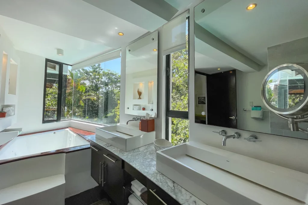 The expansive master ensuite bathroom features a luxurious soaking tub complemented by a stunning view.