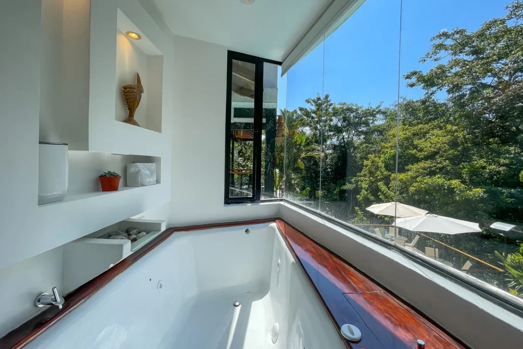 Indulge in a relaxing soak in your luxurious bath while enjoying breathtaking views of the treetop canopy.