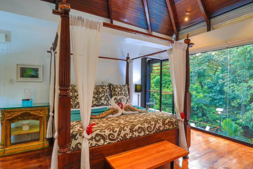 The serene rainforest view from this master bedroom adds a touch of tranquility to your mornings.