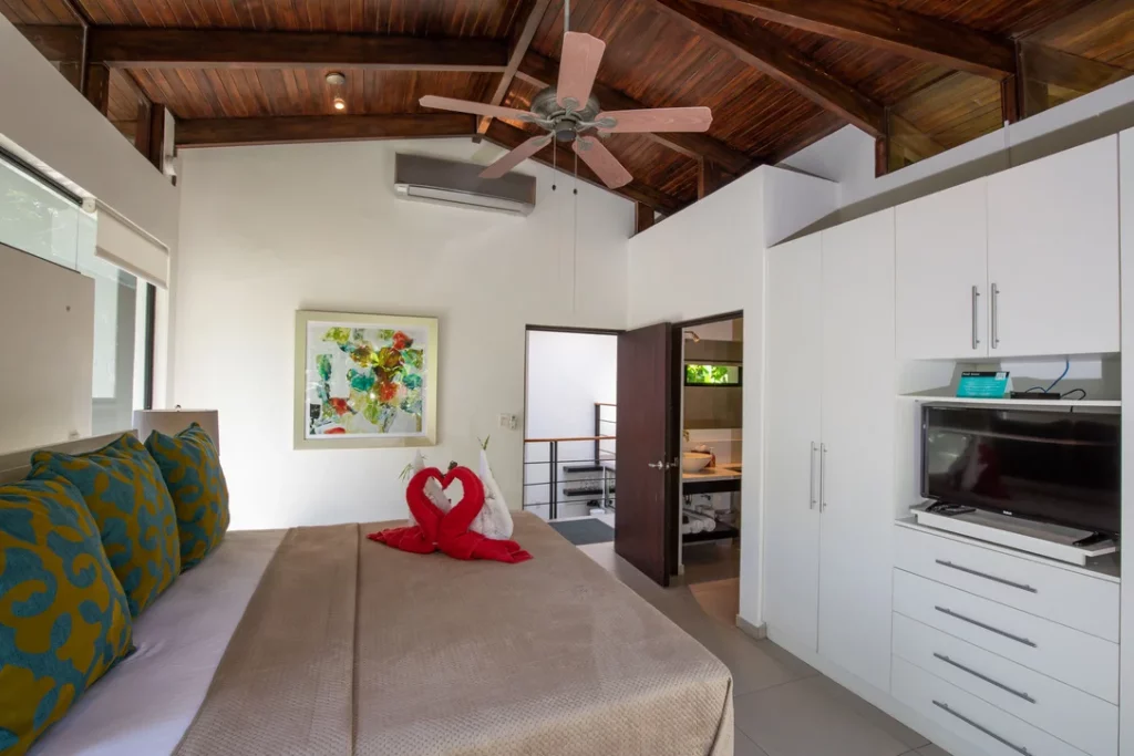 A stunning modern bedroom with vaulted ceilings.
