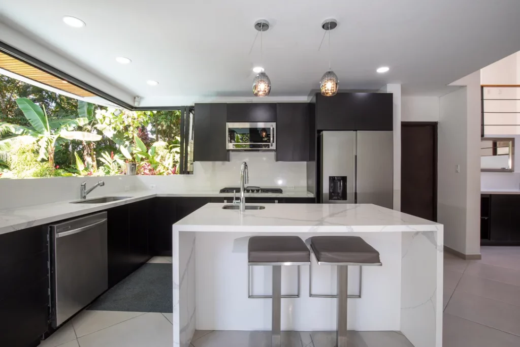 The kitchen boasts a fantastic breakfast bar with seating and is equipped with modern appliances. The open jungle view adds to its allure, creating a stunning backdrop.