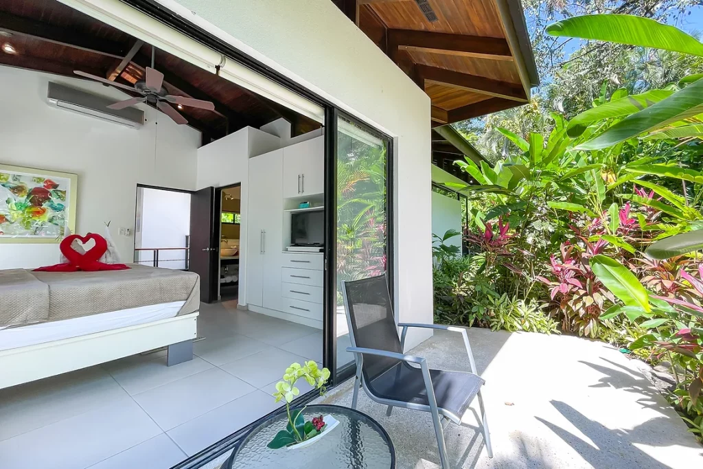 Modern bedroom patio, with lush garden views. 
