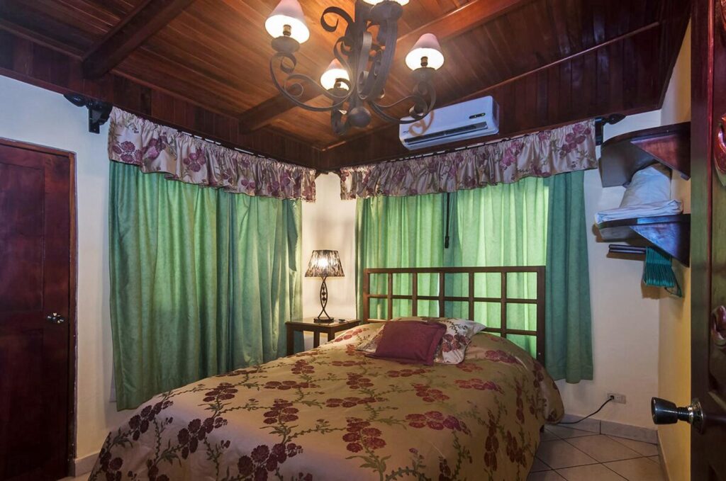 The air-conditioned bedrooms have high wooden ceilings. 
