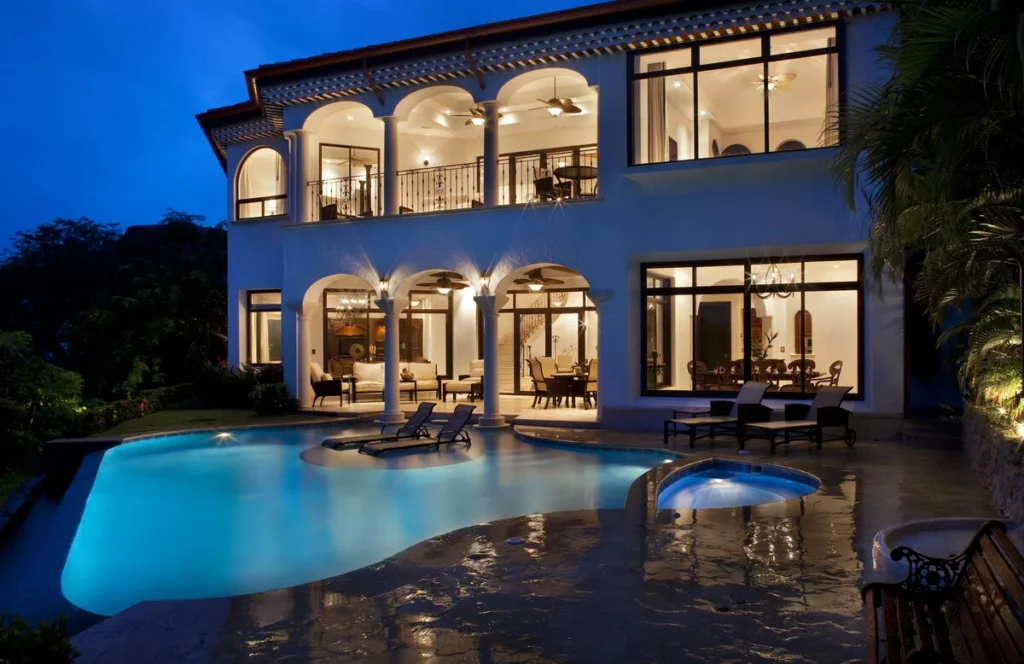 The villa glows beautifully at night — perfect for a late soak in the inviting Jacuzzi tub.