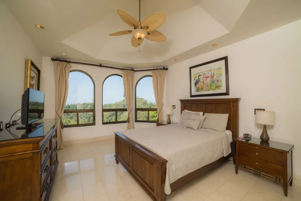 Wake up each day to a spectacular view from this inviting bedroom — pure comfort in paradise.