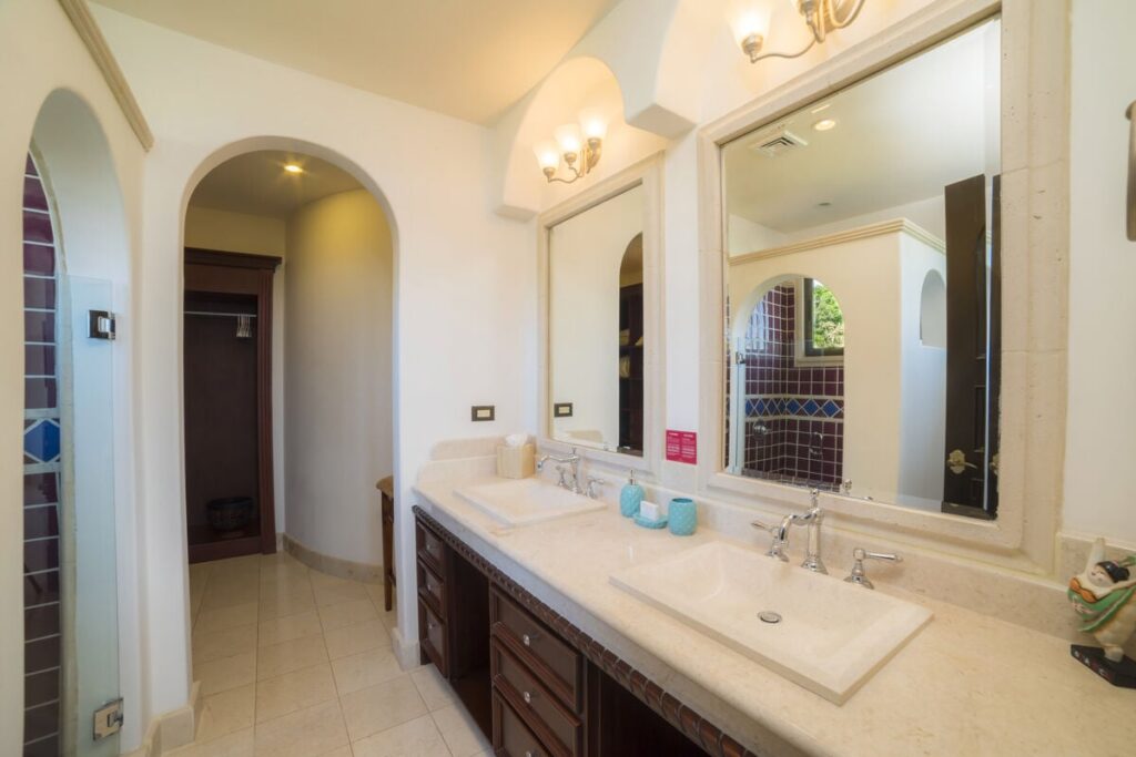Handcrafted woodwork and intricate tile designs elevate the style of the elegant bathrooms.