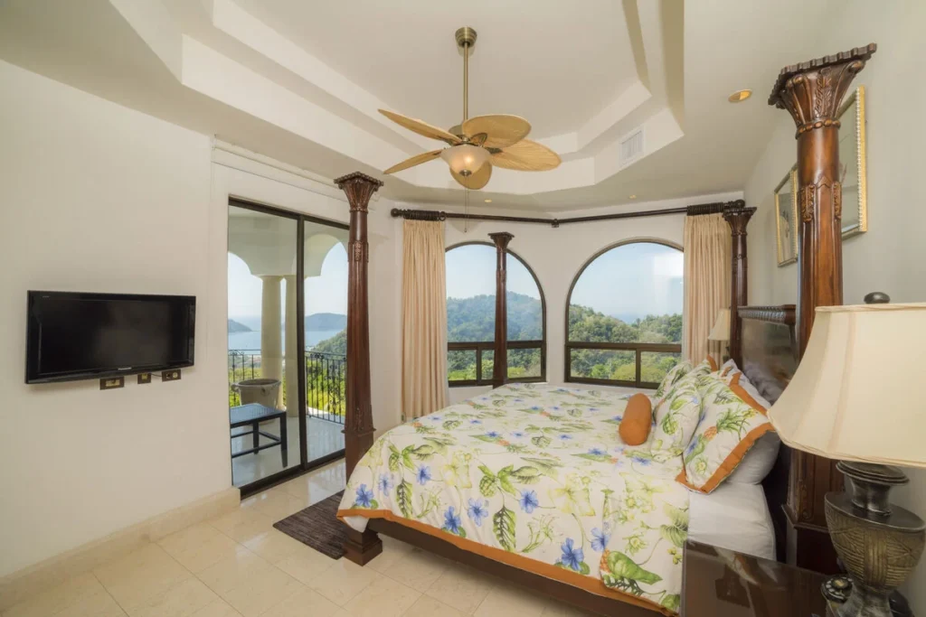 Step onto the balcony from this bedroom, furnished with an elegant four-poster king bed.