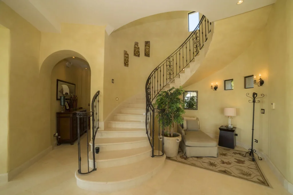 A beautiful spiral staircase adds a sophisticated design element to the villa’s interior.
