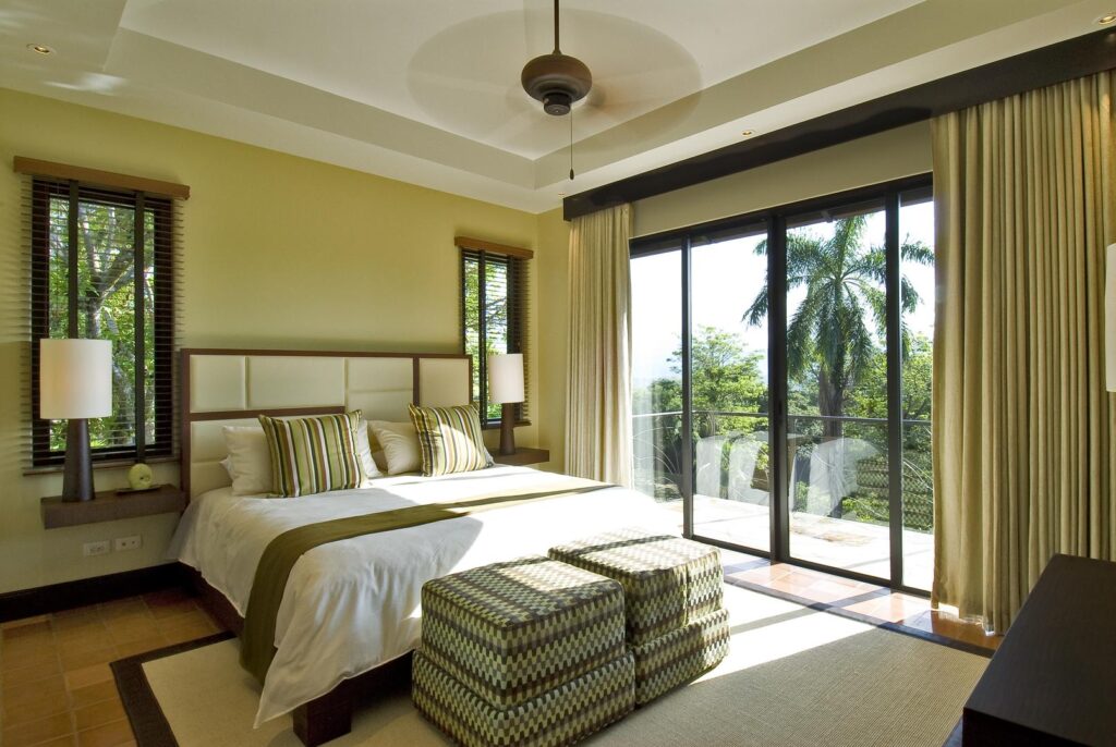 Light-filled guest suite overlooking lush tropical greenery.