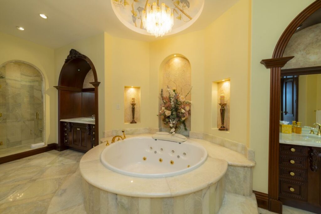 A spa-inspired bathroom centered around a soaking jacuzzi, designed for relaxation in a refined setting.