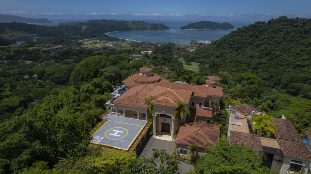 aerial view los suenos luxury villa helipad ocean coastline rainforest costa rica