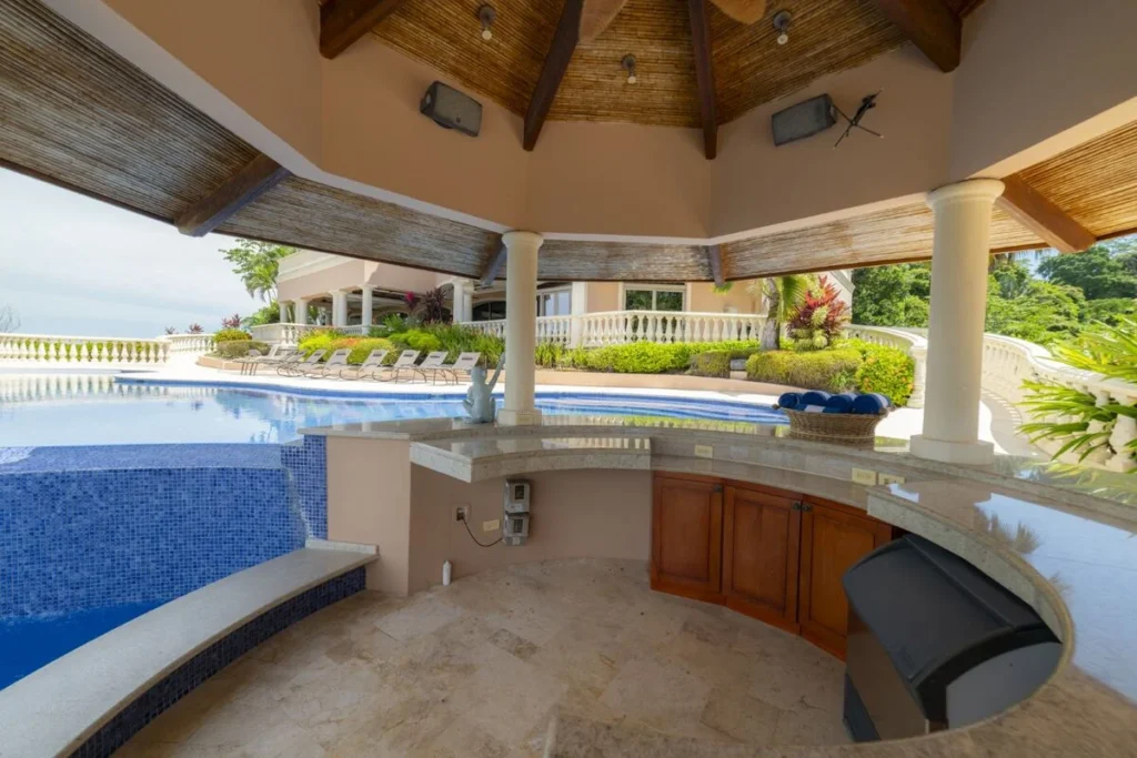 A shaded swim-up bar designed for effortless afternoons by the pool, where indoor comfort meets open-air living.