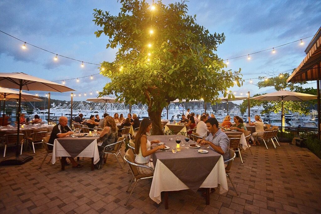 Evening dining at Los Sueños Marina, where open-air restaurants, soft lighting, and harbor views create a vibrant and inviting atmosphere.
