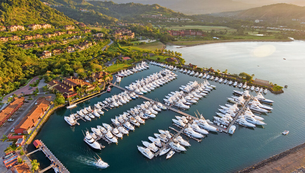 Aerial view of Los Sueños Marina, home to a world-class fleet of yachts set against the coastline and lush tropical surroundings.