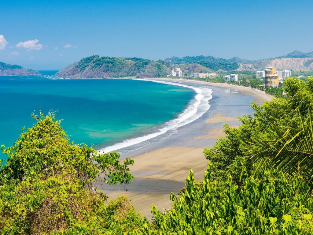 Jacó Beach stretches along Costa Rica’s Pacific coast near Los Sueños, known for its expansive shoreline, ocean views, and vibrant coastal atmosphere.