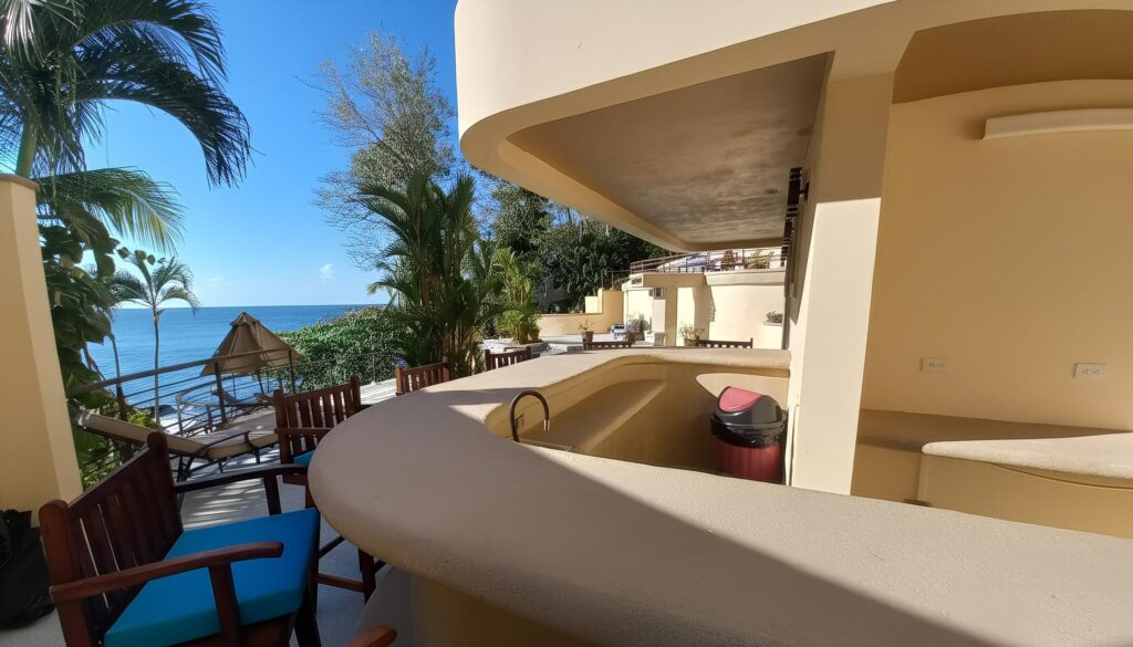 Covered outdoor bar with ocean views, offering a relaxed space for cocktails, casual dining, and beachfront entertaining.