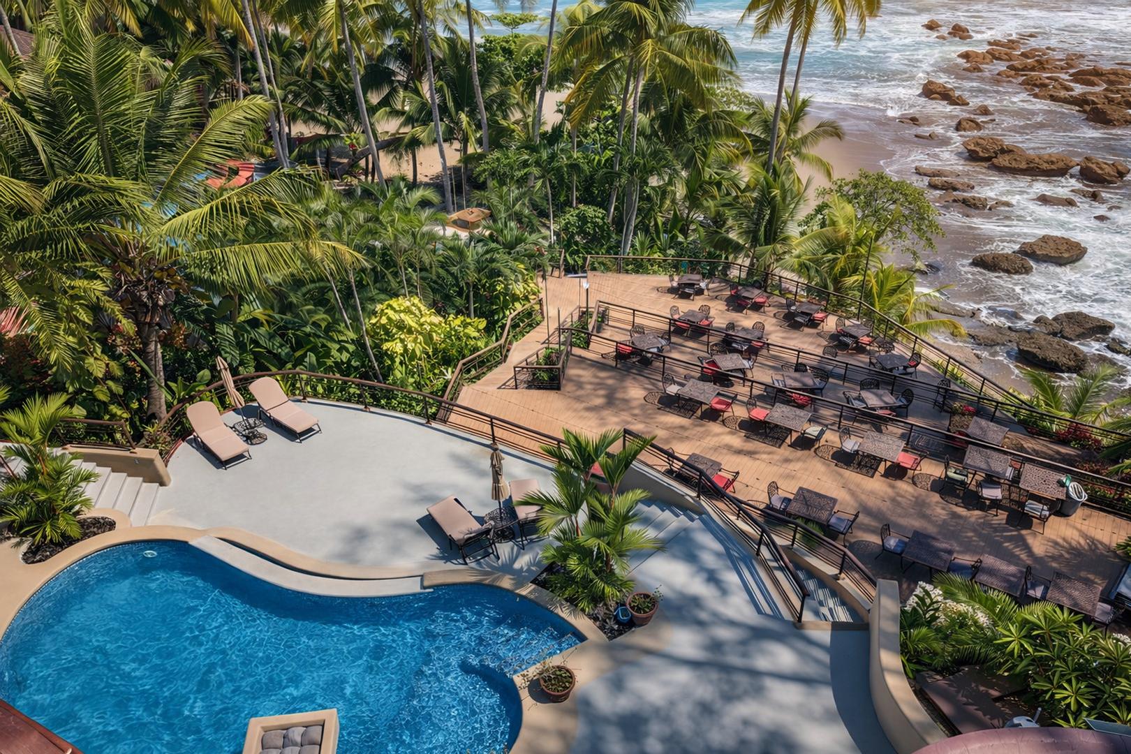 Luxury beachfront pool terrace with ocean views and outdoor lounge areas in Costa Rica