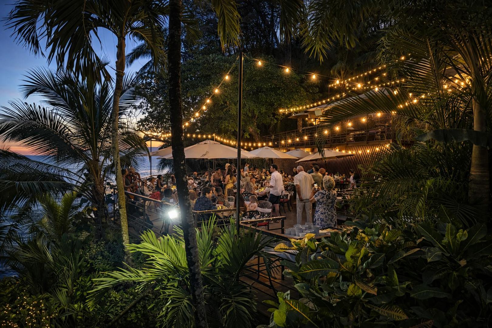 Private oceanfront event deck with string lights set for a beachfront celebration at a luxury villa in Costa Rica
