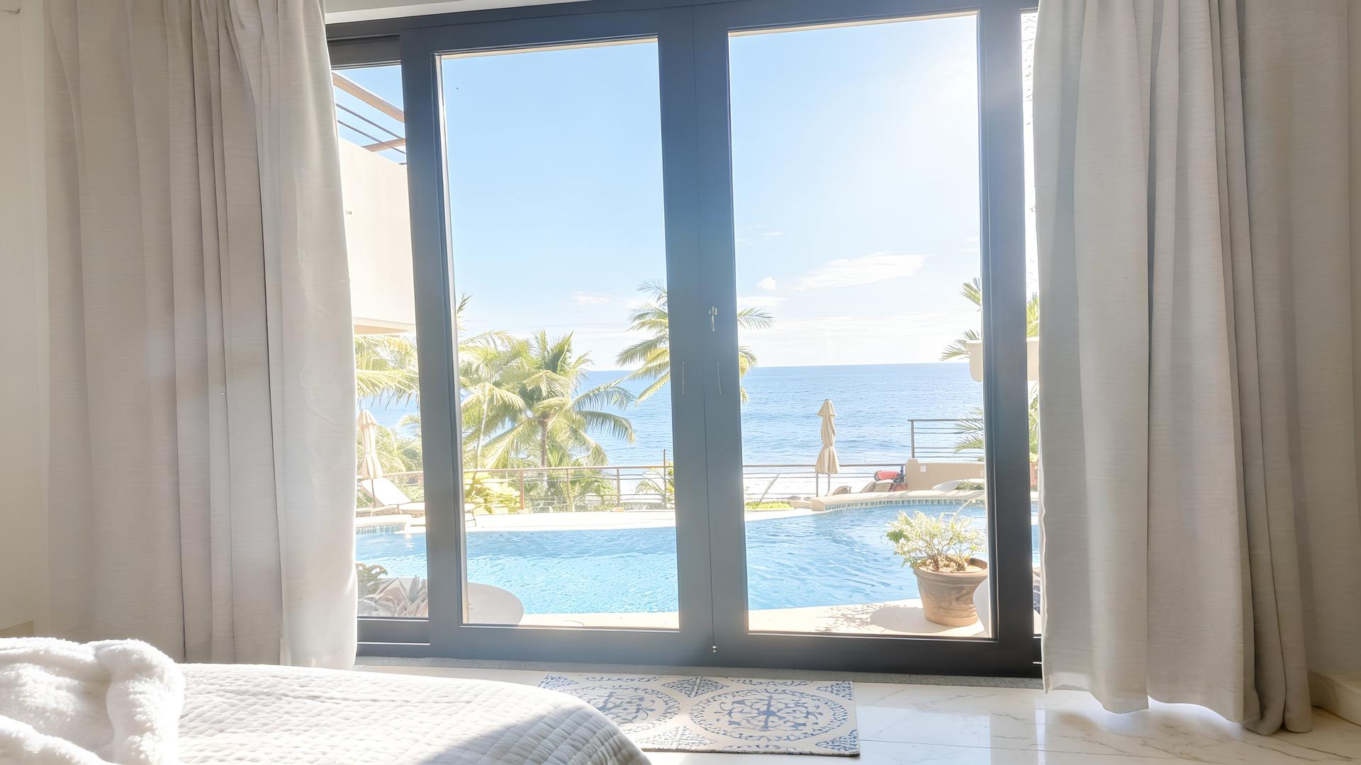 Ocean-view bedroom overlooking the pool and Pacific Ocean in a Costa Rica luxury beachfront villa