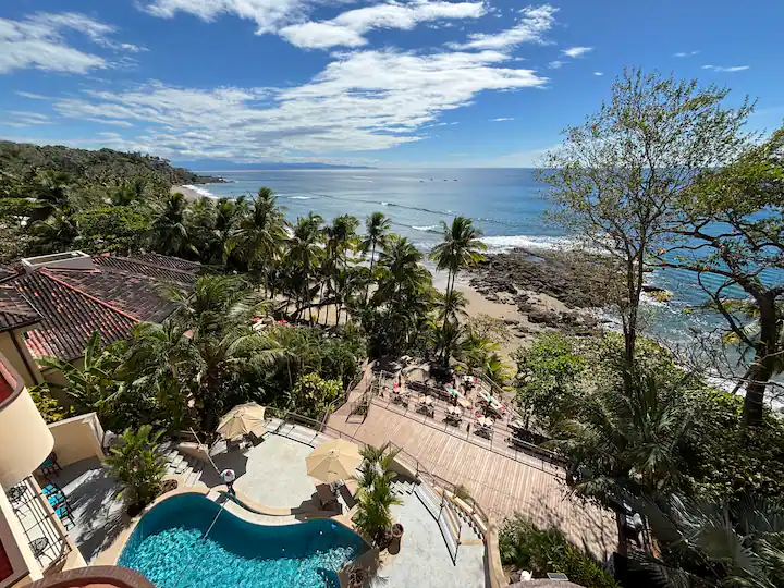 Panoramic ocean view overlooking a beachfront pool and outdoor terrace at a Costa Rica luxury villa
