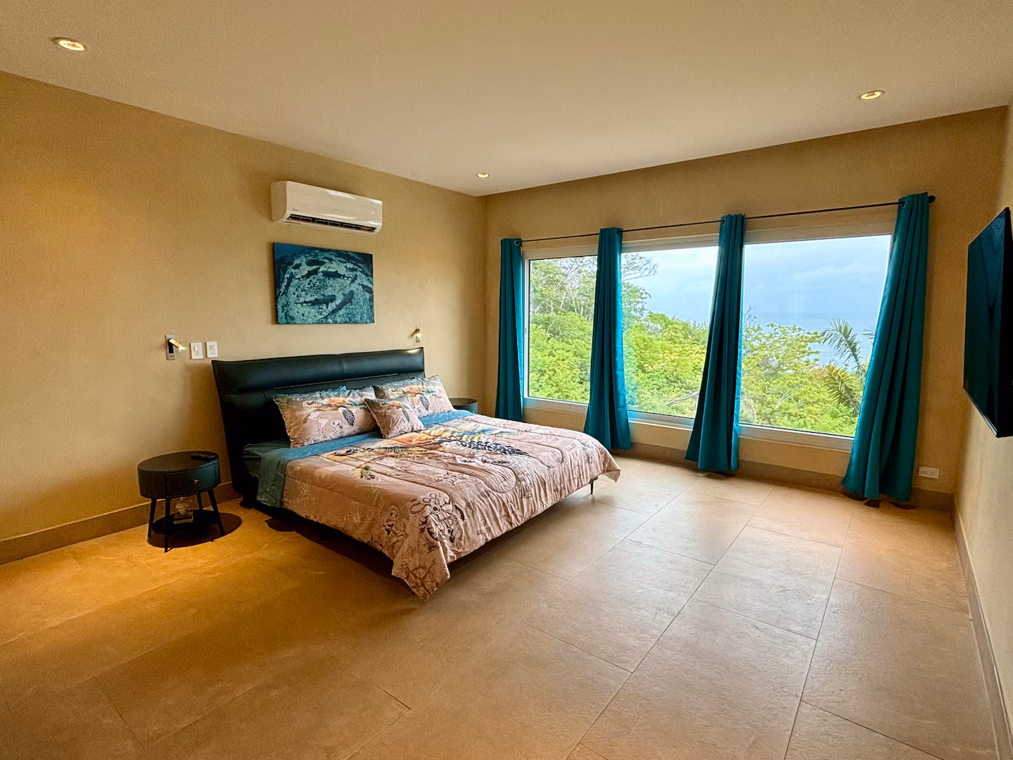 King bedroom with tropical forest and partial ocean views in a Costa Rica family vacation villa