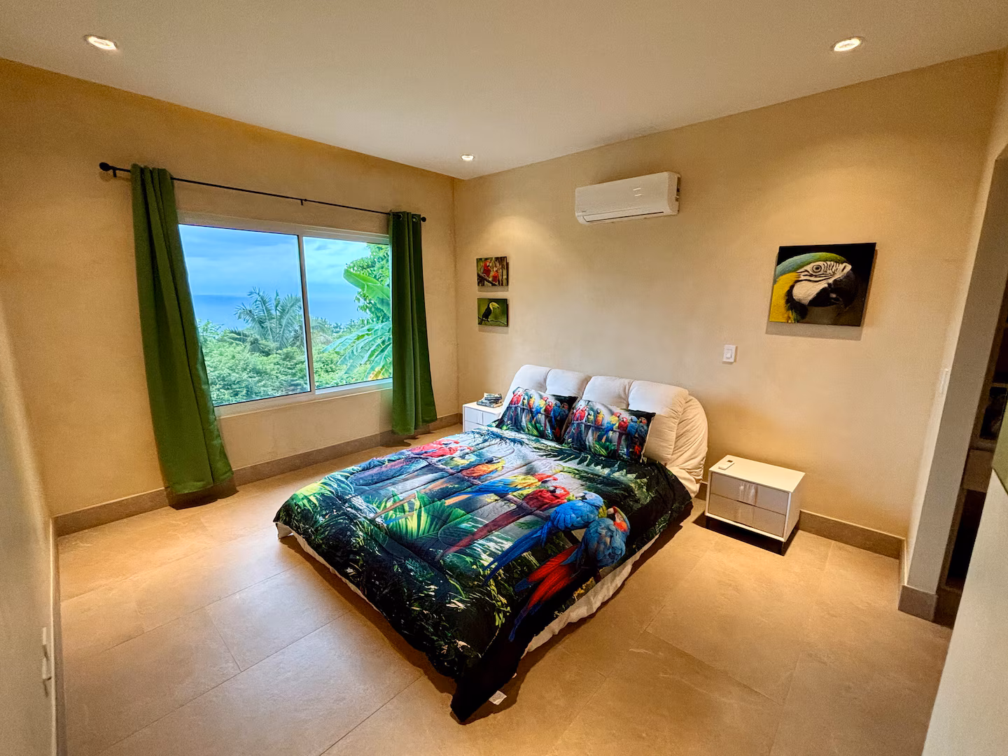 Macaw-themed bedroom with ocean view at a family vacation villa in Costa Rica