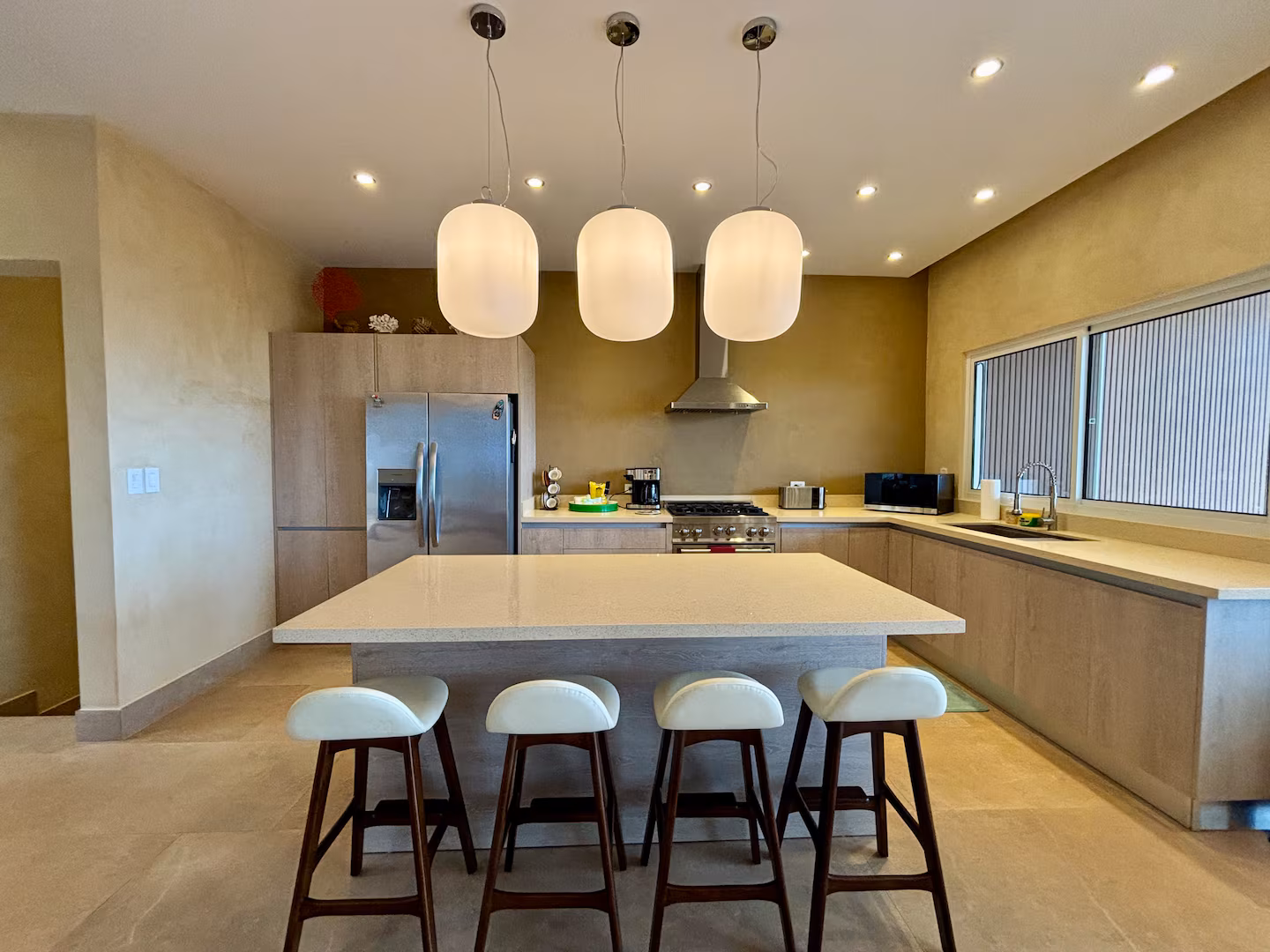 Spacious family kitchen with large island and modern appliances in a Costa Rica vacation villa