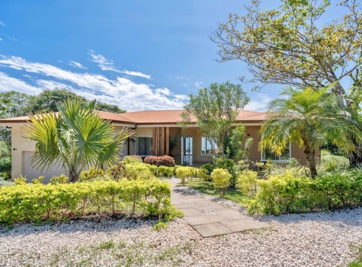 Front entrance of a Costa Rica family vacation villa surrounded by tropical gardens