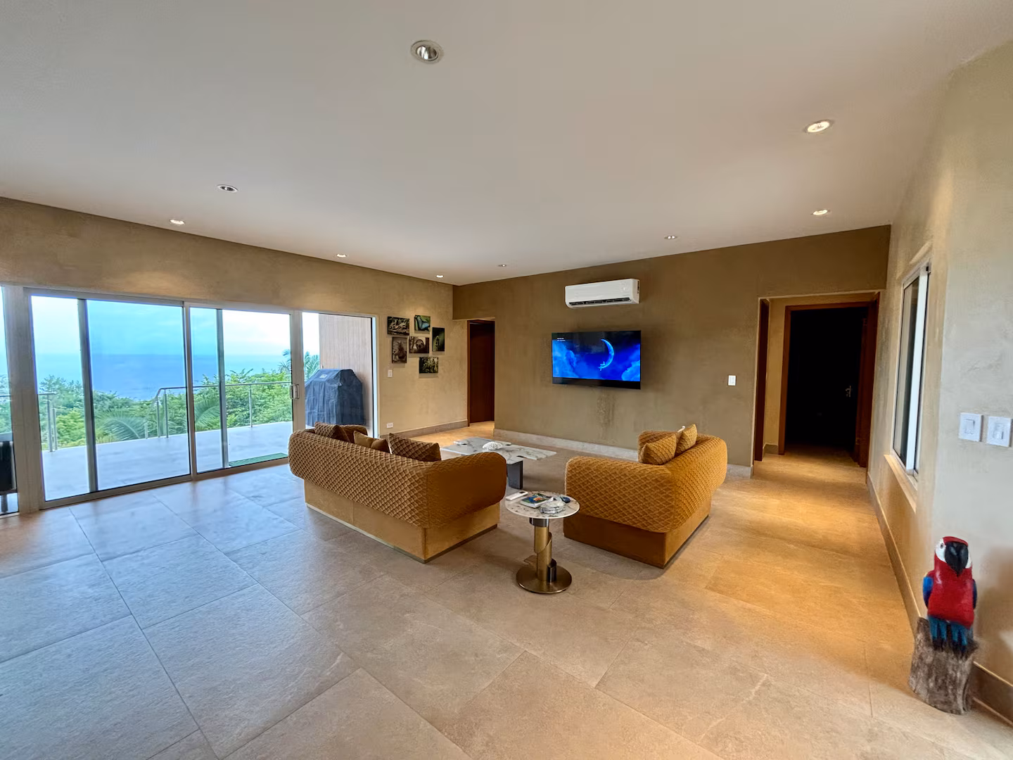 Spacious family living room with ocean views and direct access to the outdoor terrace in Costa Rica